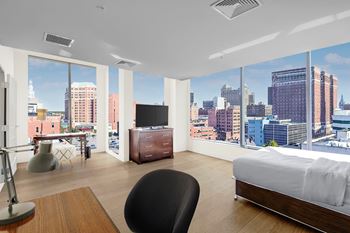a hotel room with a bed and a view of the city